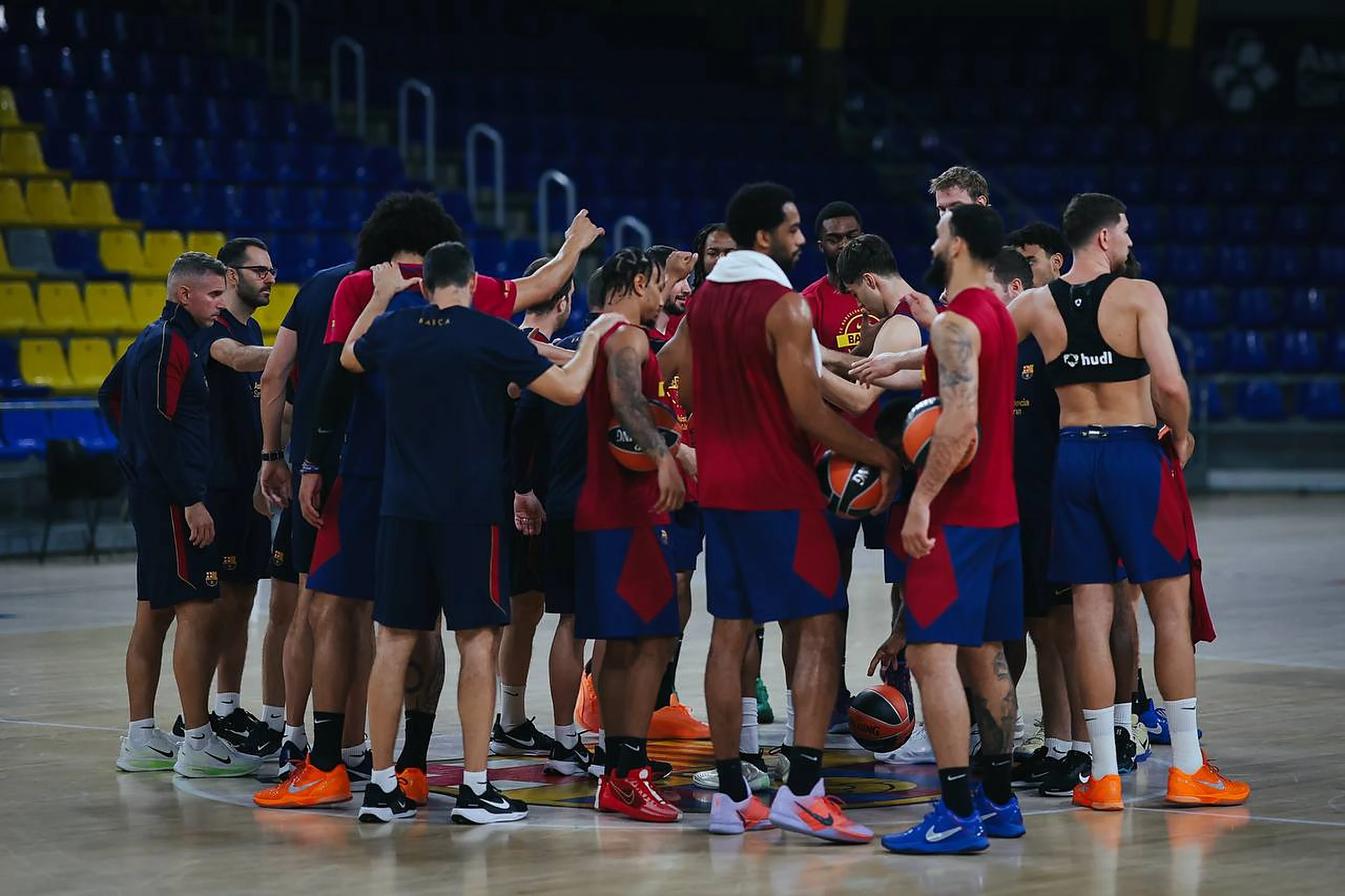 Jugadores y cuerpo técnico del Barça hacen piña en el centro de la pista durante un entrenamiento